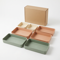 White-background concept image of seven trays and unprinted kraft packaging